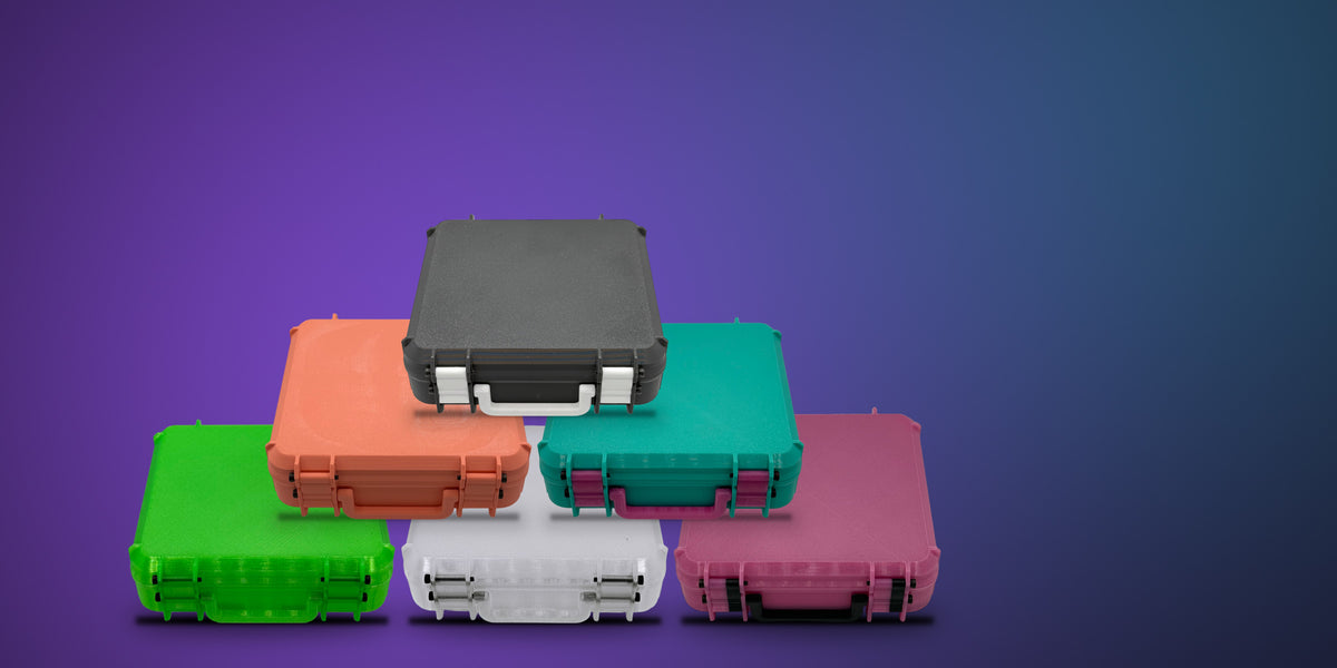 Six STASHIE kits stacked in a pyramid on a dark purple background